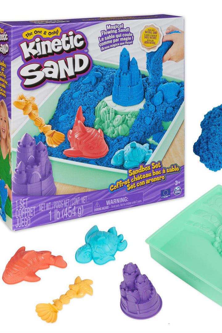 Photo of Kinetic Sand box with accessories around it. 