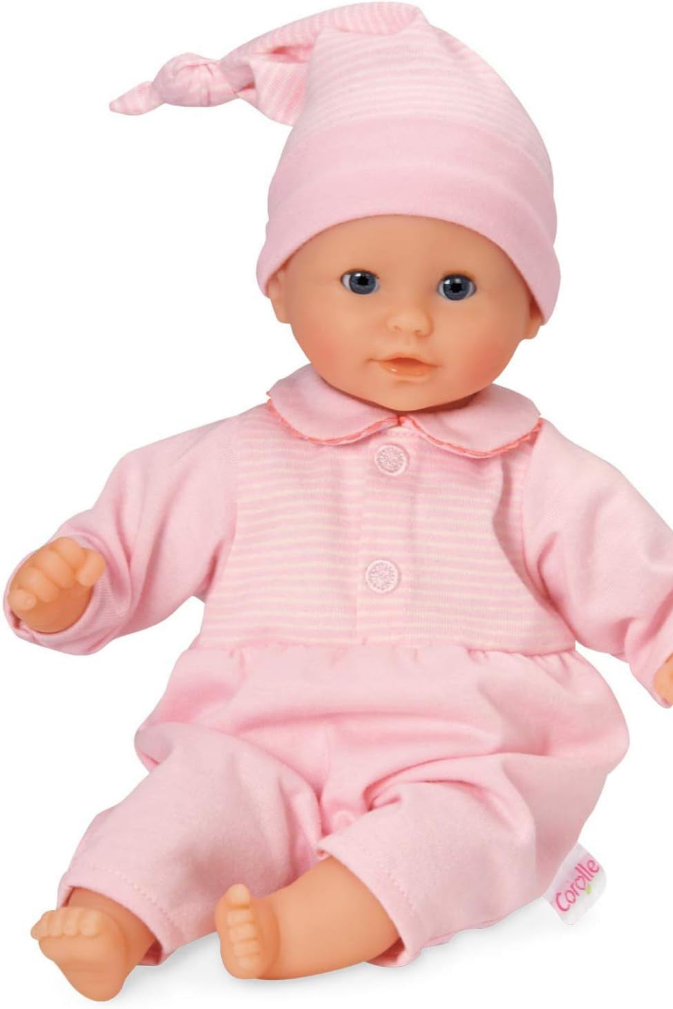 Baby doll in pink outfit and hat on a white background