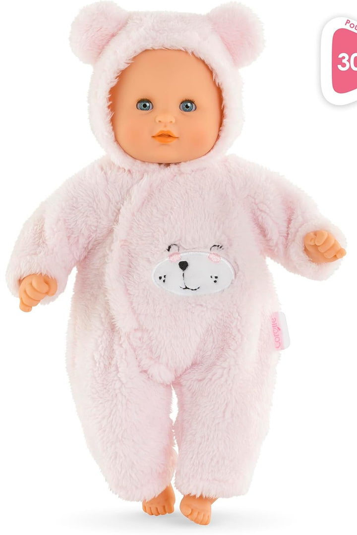 Baby doll in a pink bear onesie with a measurement label on a white background