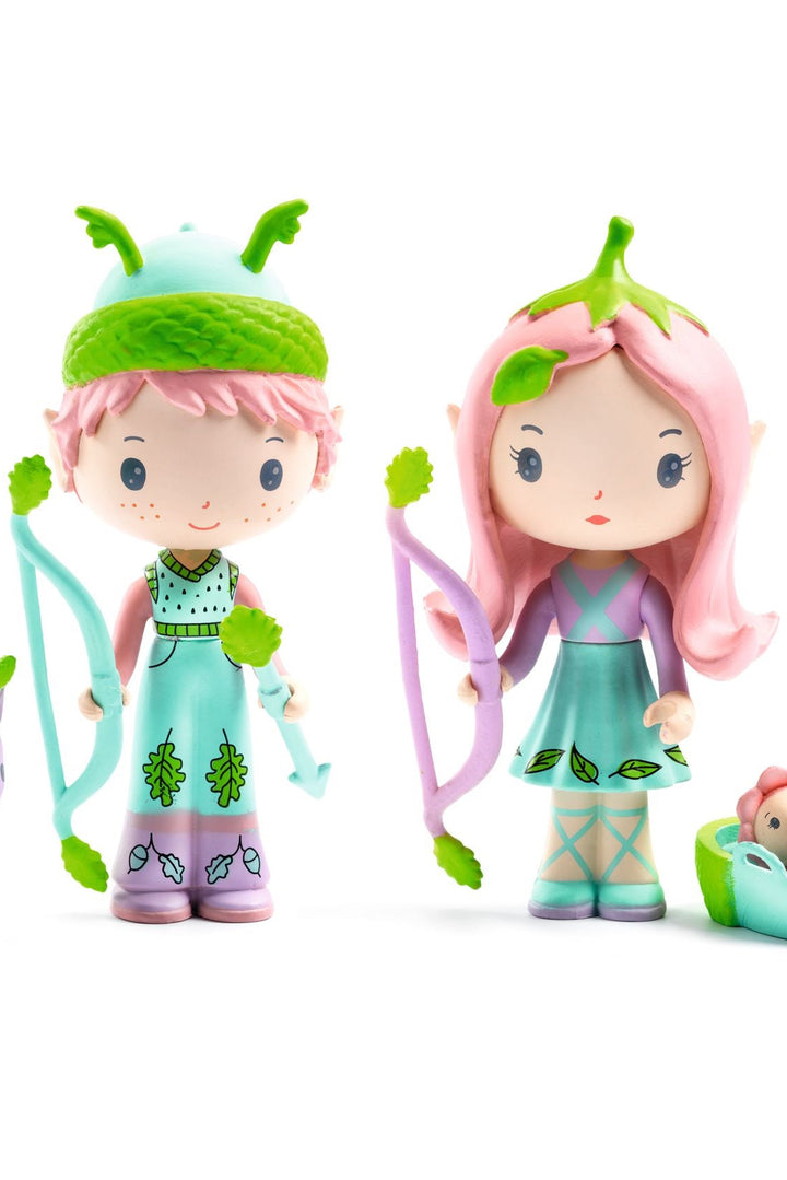 Two animated characters with green hair and outfits, standing next to a small purple creature and a baby in a basket.