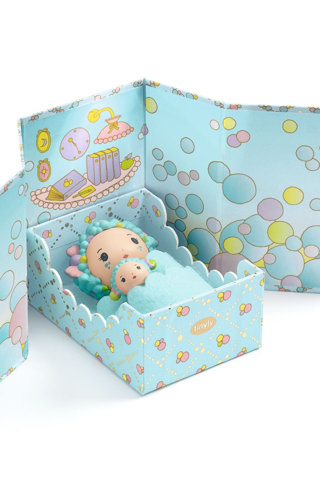 Toy figure in a decorative box with bubble-themed design on a white background