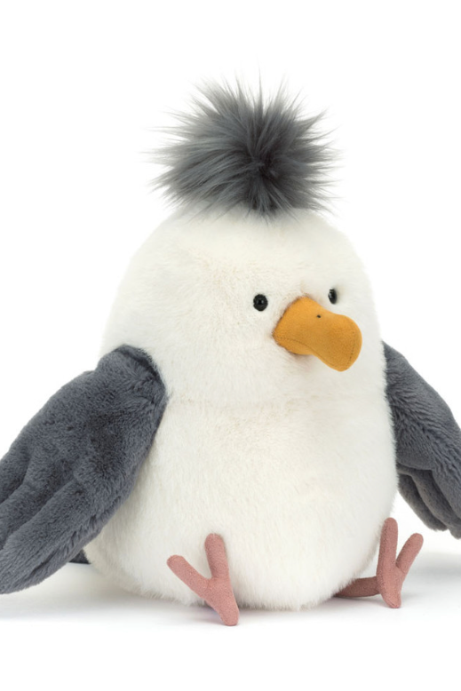 Plush penguin toy with gray wings and a white body on a white background