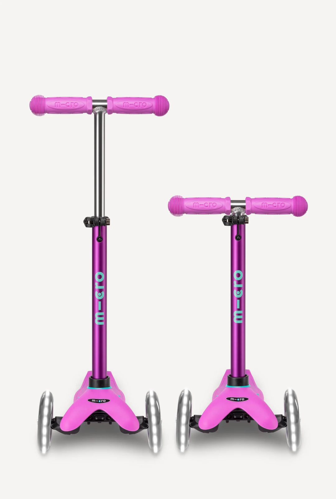 Two pink scooter with purple handles on a white background