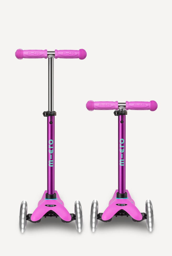 Two pink scooter with purple handles on a white background