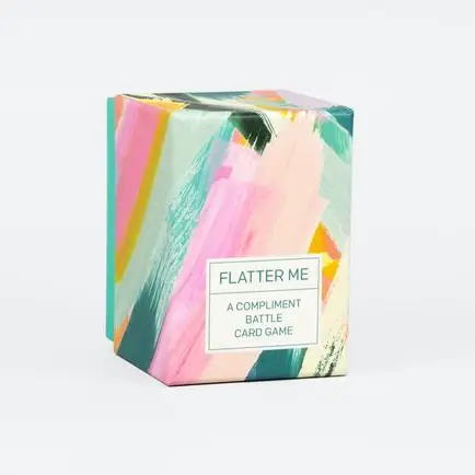 Colorful box of 'Flatter Me' card game on a white background