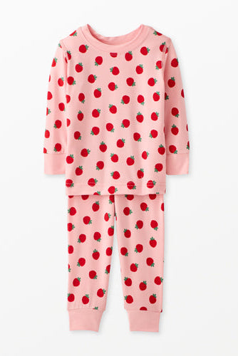 Pink pajama set with red apple pattern on a white background