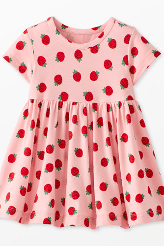 Pink dress with red strawberry pattern on a white background
