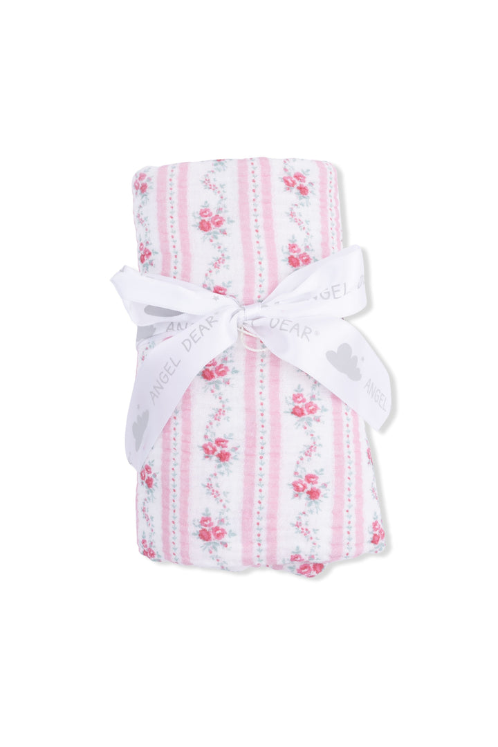 Pink and white striped fabric with floral patterns and a white ribbon on a white background